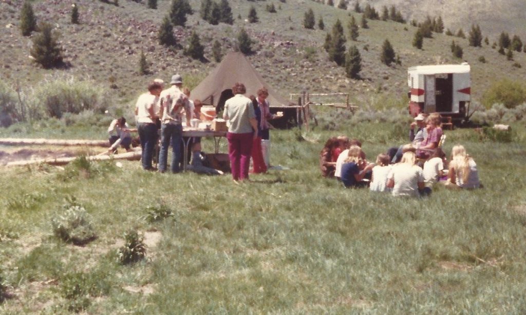 Group of people at campsite in the mountains